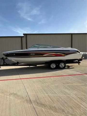 Slide: The Image of 2008 Formula 260 Bow Rider boat on trailer, parked outdoors under clear sky. - 8