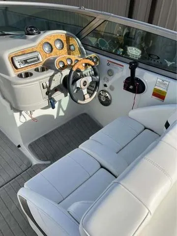 Slide: The Image of 2008 Formula 260 Bow Rider boat interior with white seating and wood-accented dashboard. - 9