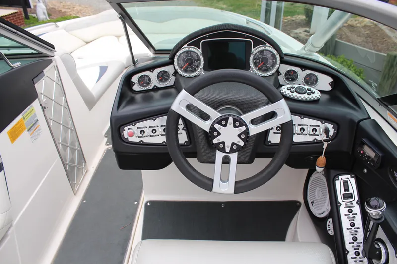 Slide: The Image of 2010 MasterCraft X-45 boat dashboard with steering wheel and control panel. - 11