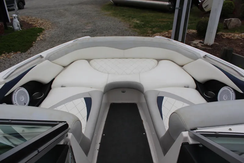 Slide: The Image of 2010 MasterCraft X-45 boat interior with white cushioned seating and speakers. - 12