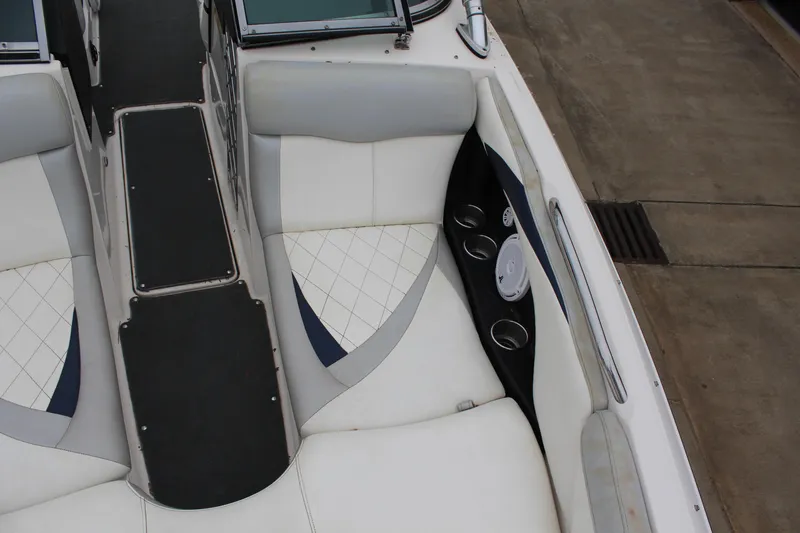 Slide: The Image of 2010 MasterCraft X-45 boat interior with white seating and cup holders. - 13