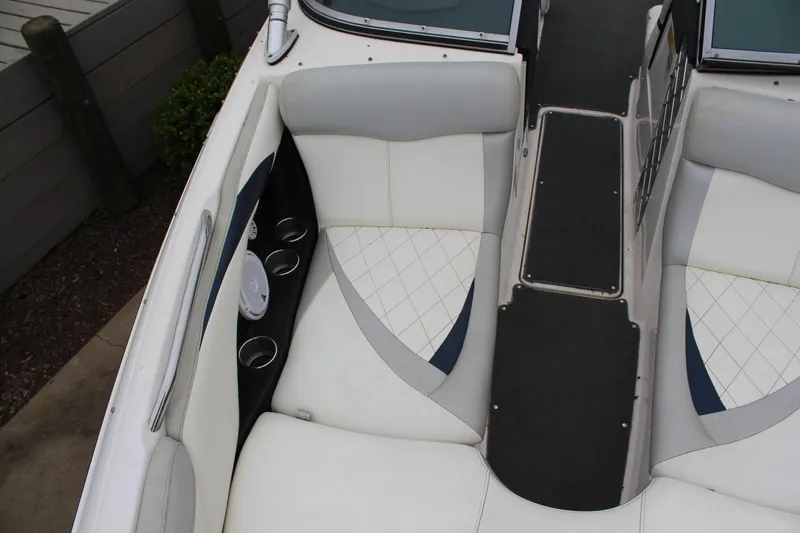Slide: The Image of 2010 MasterCraft X-45 boat interior with white seating and cup holders. - 14