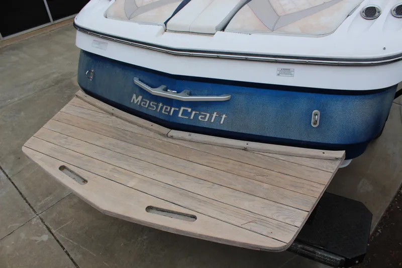 Slide: The Image of 2010 MasterCraft X-45 boat with wooden swim platform, rear view. - 16