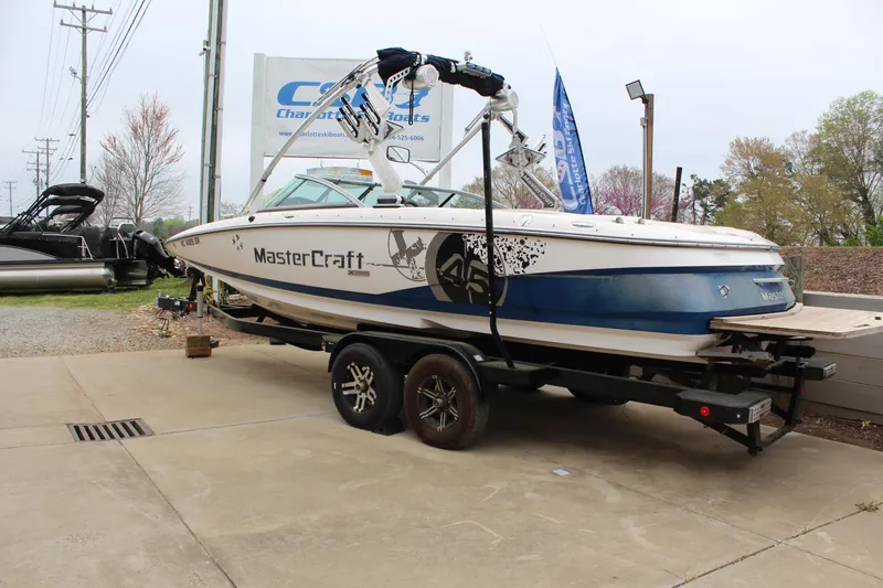 Slide: The Image of 2010 MasterCraft X-45 boat on trailer, parked outdoors near dealership. - 3