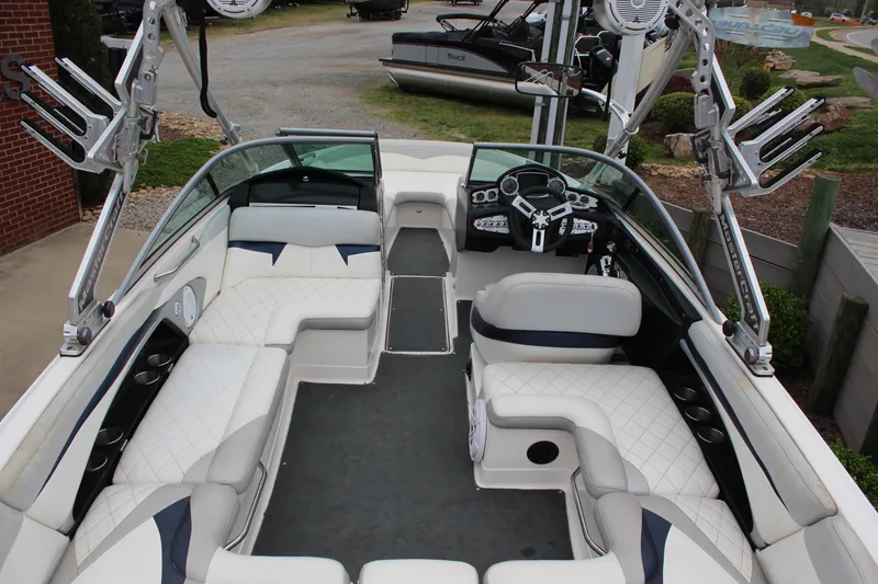 Slide: The Image of 2010 MasterCraft X-45 boat interior with white seating and modern dashboard. - 6