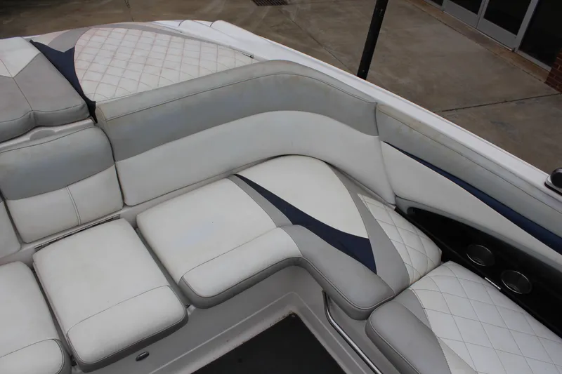 Slide: The Image of 2010 MasterCraft X-45 boat interior with white and gray cushioned seating. - 7