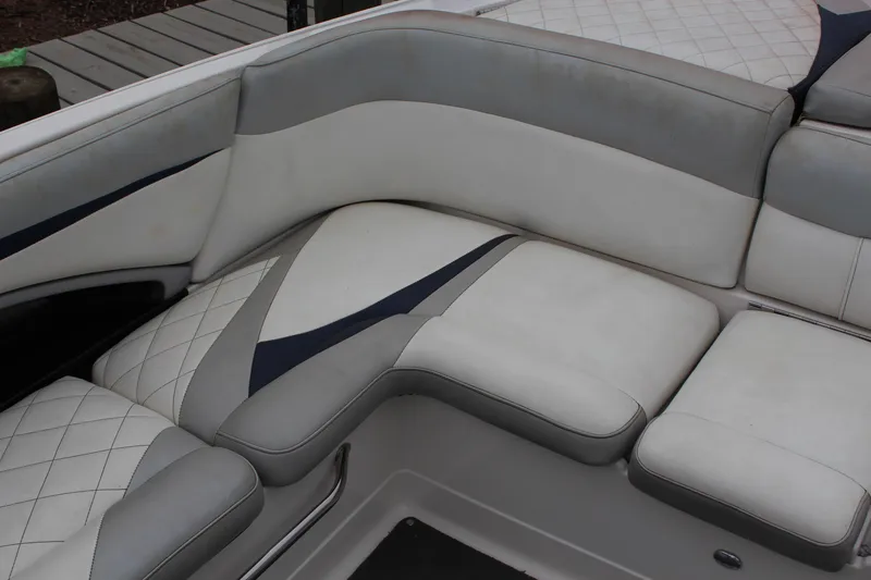 Slide: The Image of 2010 MasterCraft X-45 boat interior with gray and white cushioned seating. - 8