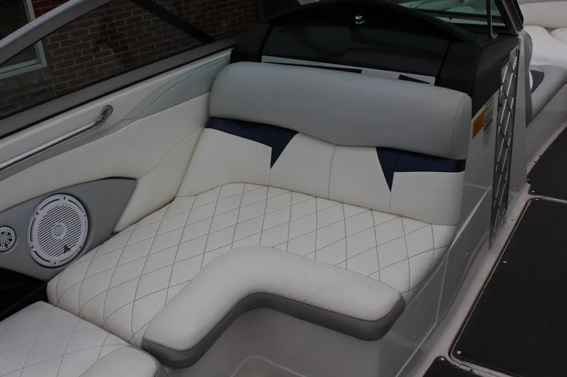 Slide: The Image of 2010 MasterCraft X-45 boat interior with white quilted seating and speaker detail. - 9