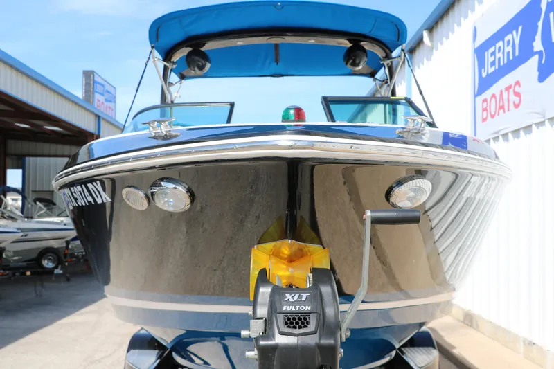 Slide: The Image of 2018 Regal 23 RX Surf boat with blue canopy at Jerry Boats dealership. - 10