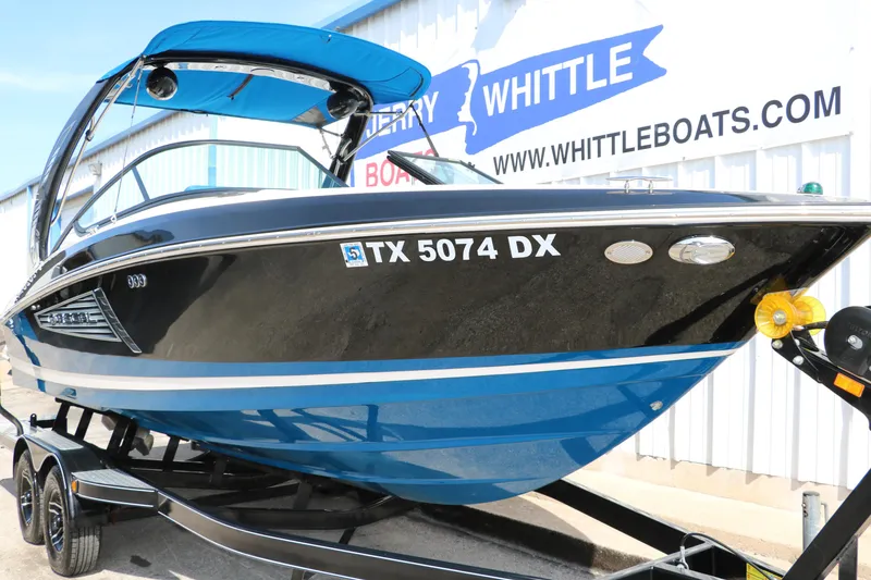 Slide: The Image of 2018 Regal 23 RX Surf boat on trailer, displayed at Whittle Boats dealership. - 12