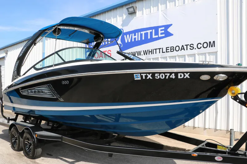 Slide: The Image of 2018 Regal 23 RX Surf boat on trailer at Whittle Boats dealership. - 13