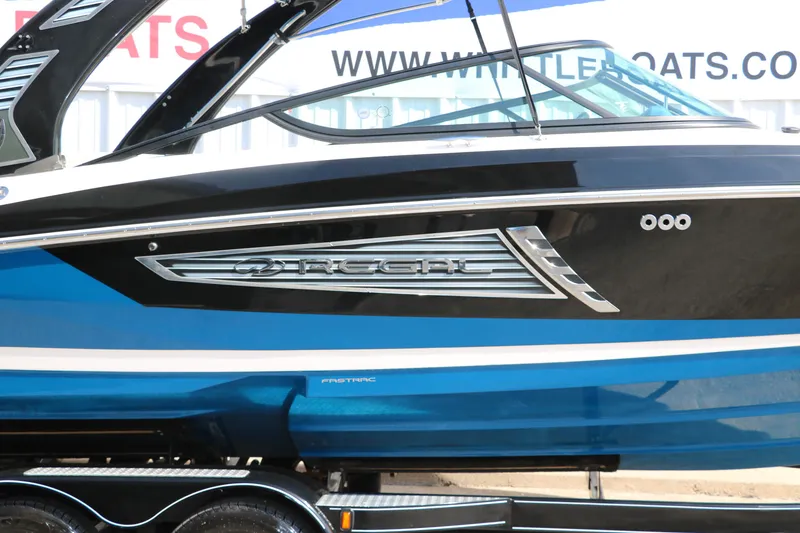 Slide: The Image of 2018 Regal 23 RX Surf boat, blue and black design, side view. - 17