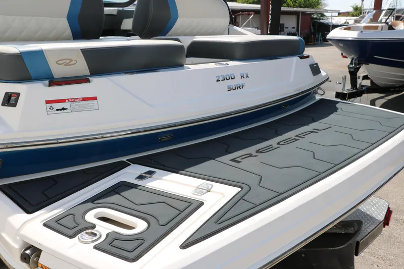 Slide: The Image of 2018 Regal 23 RX Surf boat with cushioned seating and non-slip deck. - 18