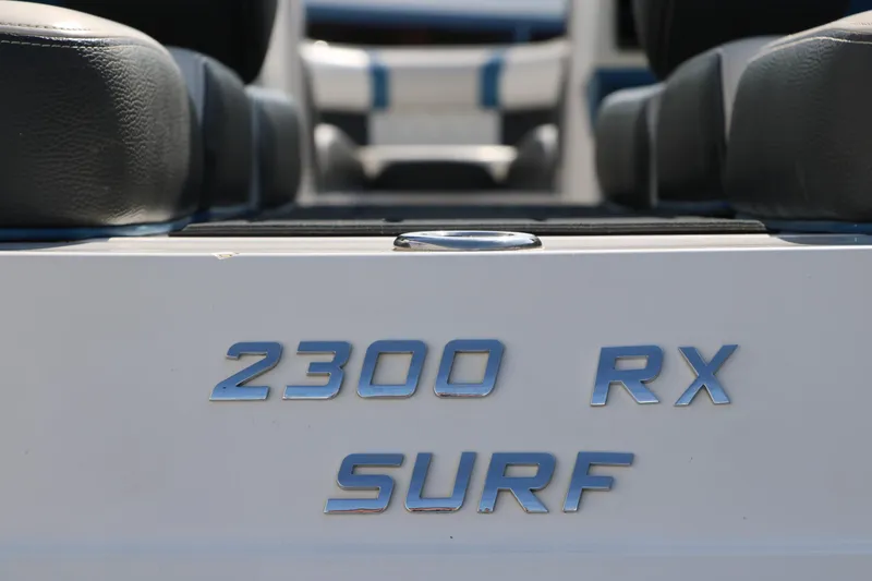 Slide: The Image of Close-up of 2018 Regal 23 RX Surf boat model name on hull. - 19