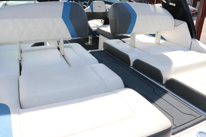 Slide: The Image of 2018 Regal 23 RX Surf boat interior with white and blue seating. - 21