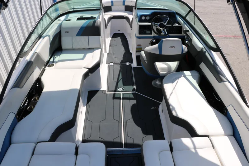 Slide: The Image of 2018 Regal 23 RX Surf boat interior with sleek seating and modern dashboard. - 23
