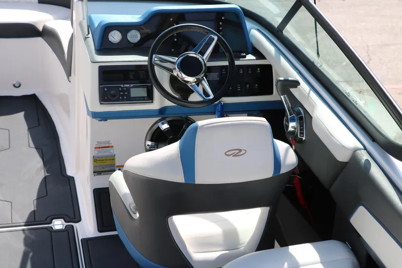 Slide: The Image of 2018 Regal 23 RX Surf boat interior with steering wheel and dashboard controls. - 24