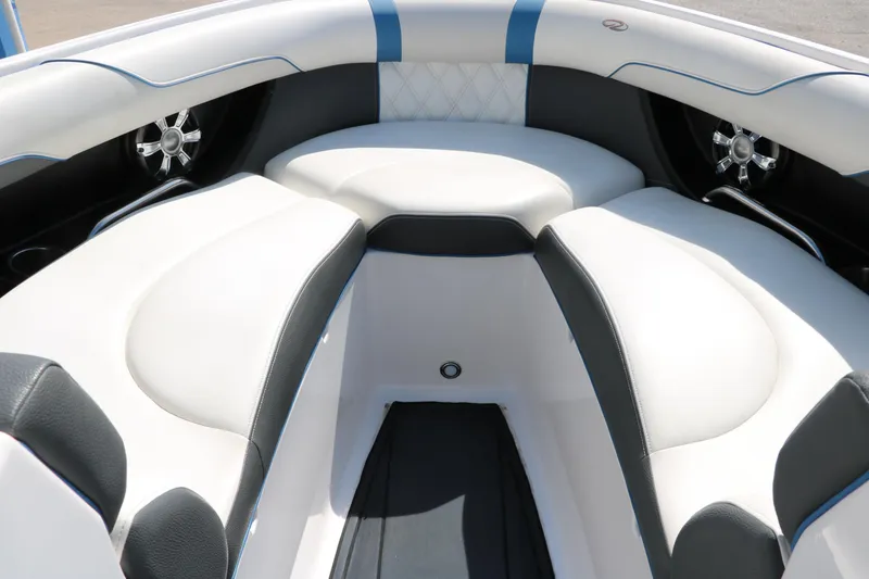 Slide: The Image of 2018 Regal 23 RX Surf boat interior with white and black seating, blue accents. - 26