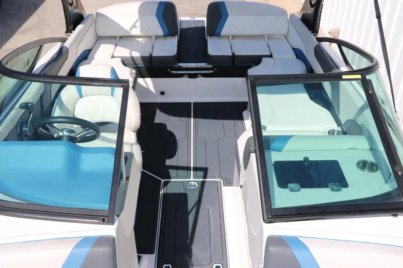 Slide: The Image of 2018 Regal 23 RX Surf boat interior with blue and white seating, open cockpit view. - 28