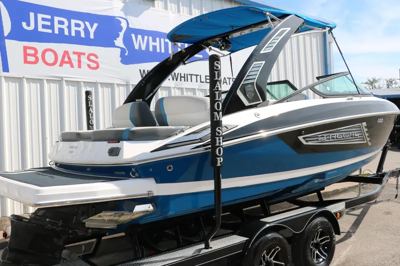 Slide: The Image of 2018 Regal 23 RX Surf boat in blue, displayed at Jerry Whittle Boats dealership. - 3
