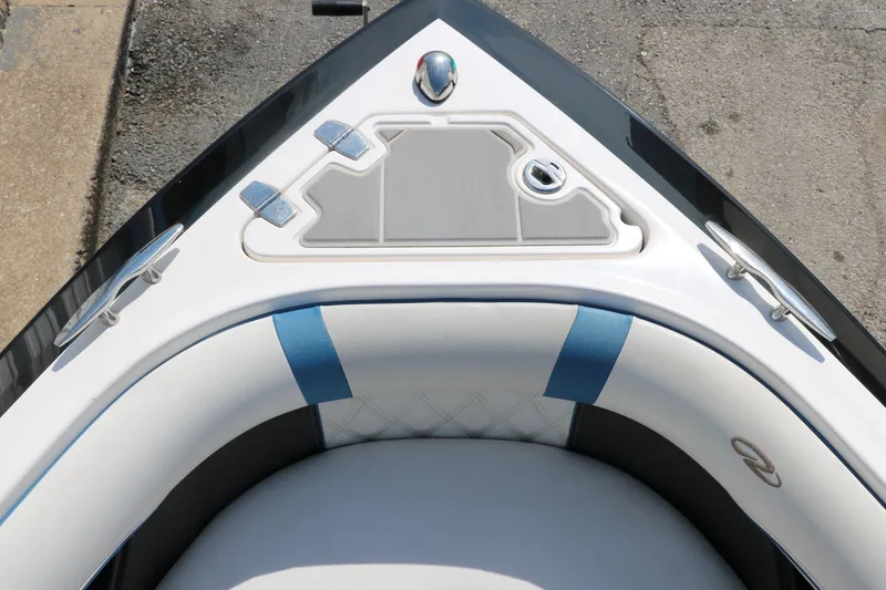 Slide: The Image of Bow of 2018 Regal 23 RX Surf boat with cushioned seating and sleek design. - 31