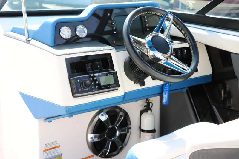 Slide: The Image of 2018 Regal 23 RX Surf boat dashboard with steering wheel and control panel. - 34