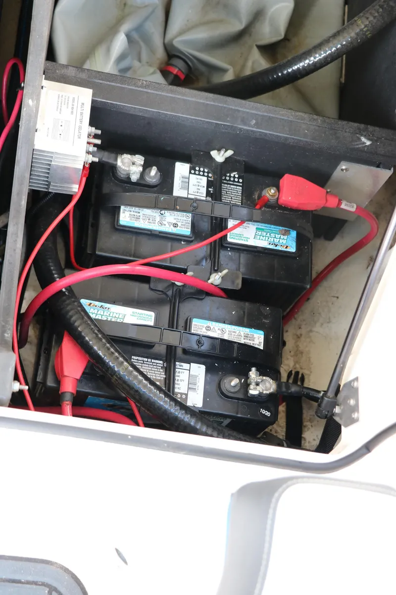 Slide: The Image of Batteries and wiring inside a 2018 Regal 23 RX Surf boat compartment. - 41