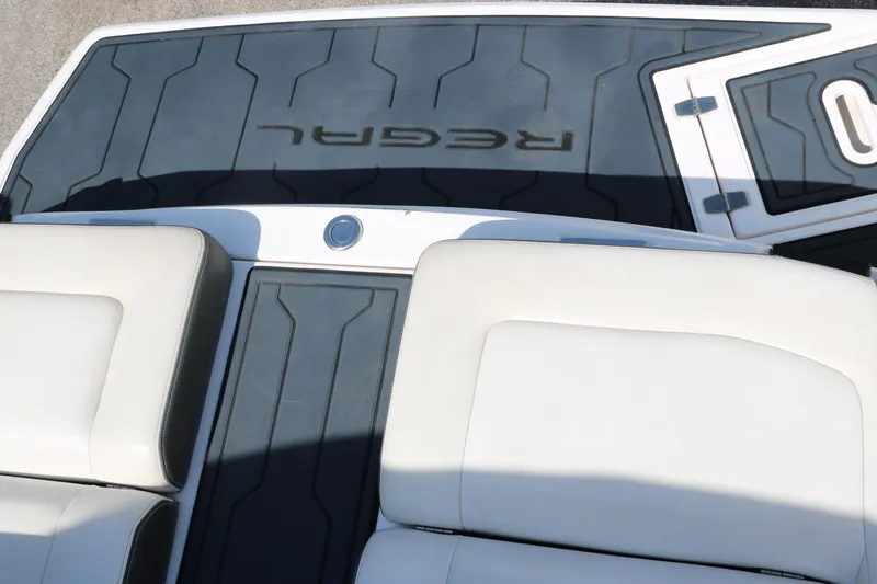 Slide: The Image of 2018 Regal 23 RX Surf boat interior with cushioned seating and branded flooring. - 42