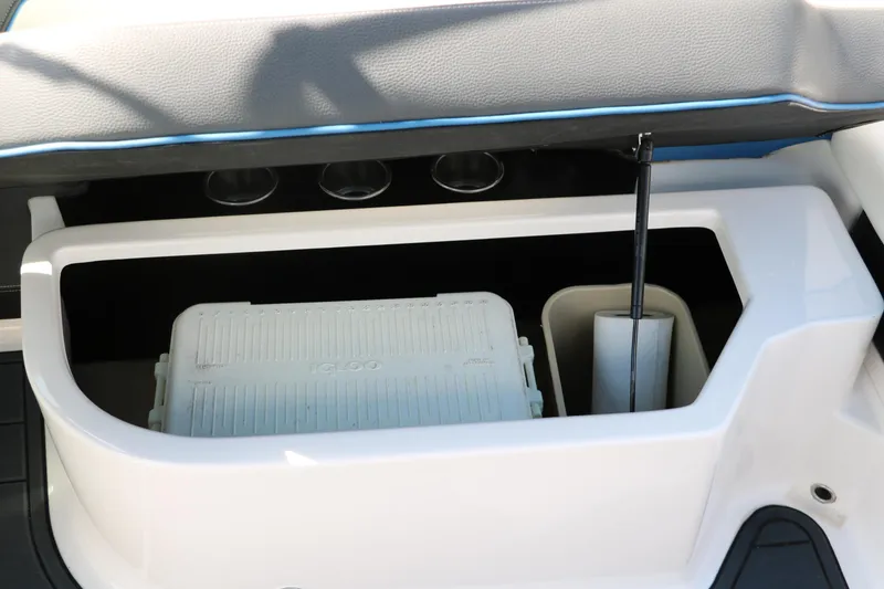 Slide: The Image of 2018 Regal 23 RX Surf boat storage compartment with cooler and accessories. - 47