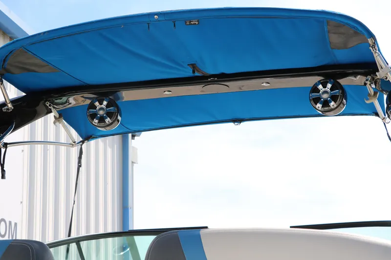 Slide: The Image of 2018 Regal 23 RX Surf boat with blue canopy and speakers. - 48