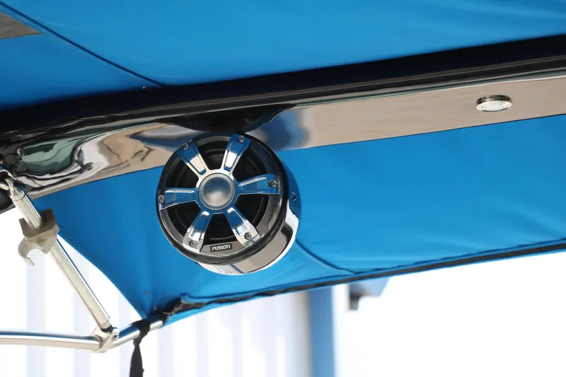 Slide: The Image of Speaker on 2018 Regal 23 RX Surf boat with blue canopy. - 49