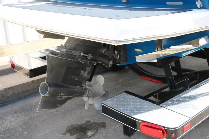 Slide: The Image of 2018 Regal 23 RX Surf boat on trailer, showing propeller and rear details. - 5