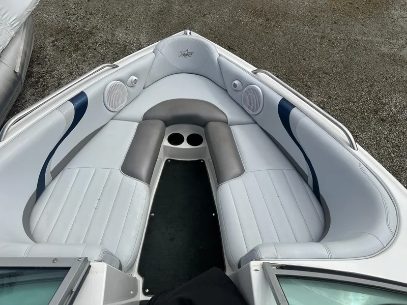 Slide: The Image of 2004 MasterCraft ProStar 209 boat interior with gray seating and cup holders. - 14