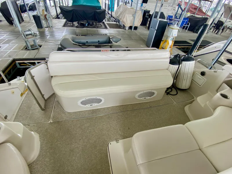 Slide: The Image of Interior of 2001 Regal Commodore 4160 boat with beige seating and speakers. - 13