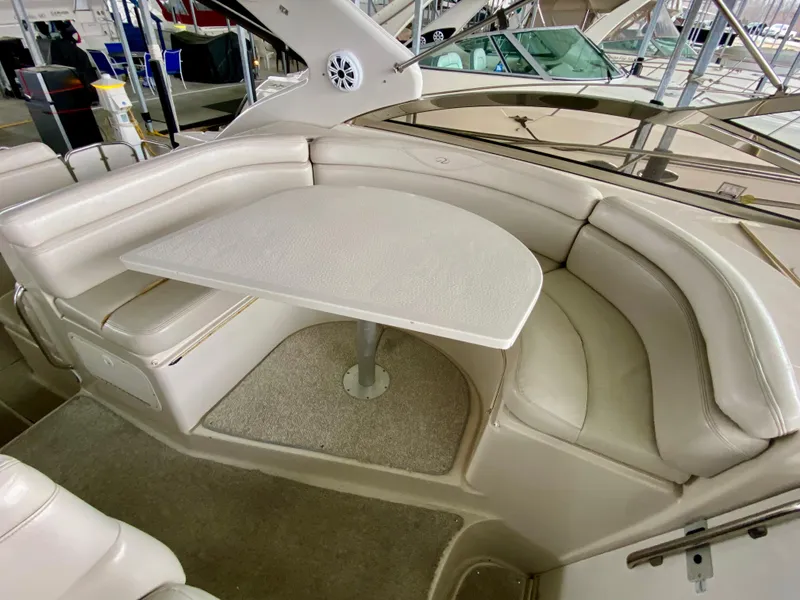 Slide: The Image of Luxurious seating area on a 2001 Regal Commodore 4160 yacht with a sleek table. - 17