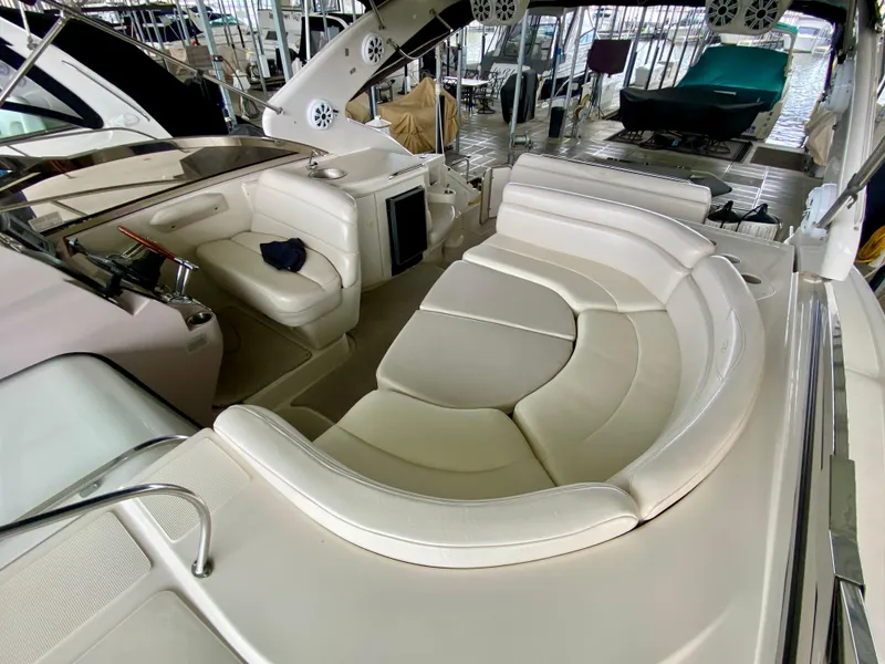 Slide: The Image of 2001 Regal Commodore 4160 yacht interior with white leather seating in a marina. - 19