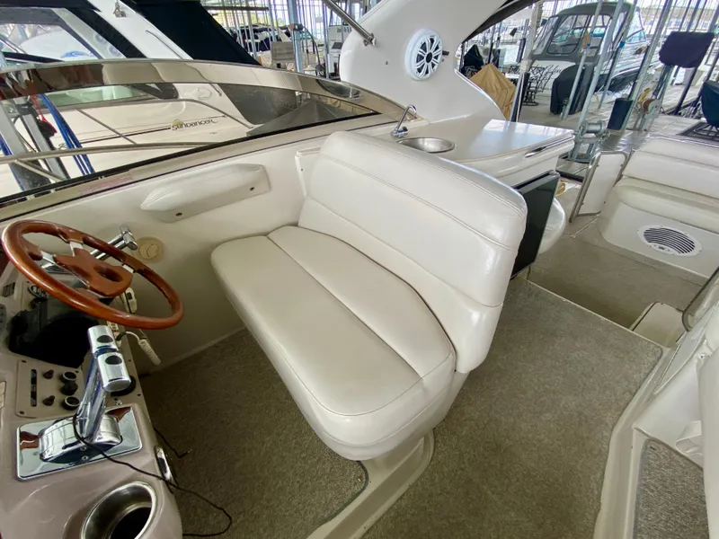 Slide: The Image of 2001 Regal Commodore 4160 boat interior with white seating and wooden steering wheel. - 21