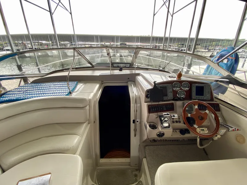 Slide: The Image of 2001 Regal Commodore 4160 yacht cockpit with steering wheel and control panel. - 22