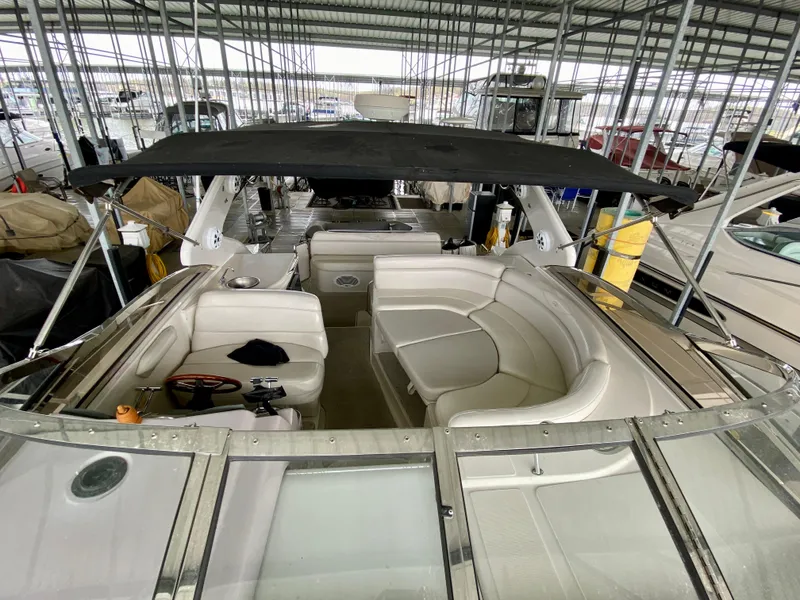 Slide: The Image of 2001 Regal Commodore 4160 boat with spacious seating under a covered dock. - 24