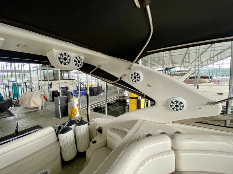 Slide: The Image of Interior view of a 2001 Regal Commodore 4160 yacht with white seating and mounted speakers. - 25
