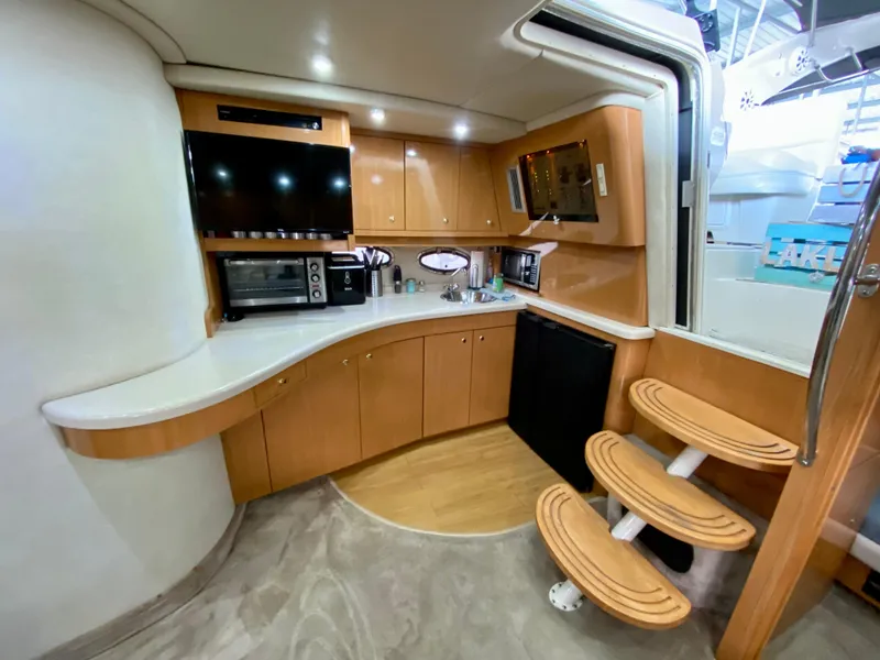 Slide: The Image of Luxurious 2001 Regal Commodore 4160 yacht interior with modern kitchen and wooden steps. - 28
