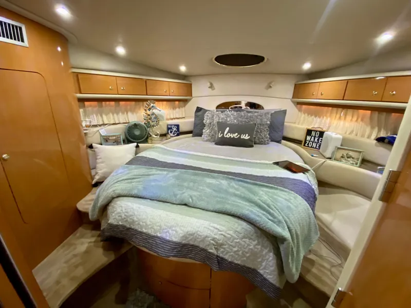 Slide: The Image of Luxurious 2001 Regal Commodore 4160 yacht bedroom with cozy bedding and ambient lighting. - 31