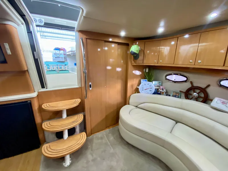 Slide: The Image of Interior of 2001 Regal Commodore 4160 yacht with curved seating and wooden cabinetry. - 34