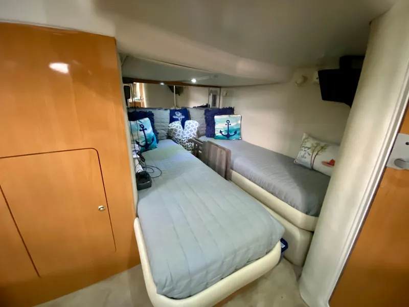 Slide: The Image of 2001 Regal Commodore 4160 cabin with twin beds and nautical-themed decor. - 37
