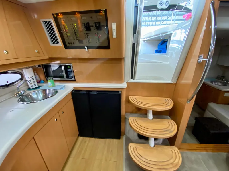 Slide: The Image of 2001 Regal Commodore 4160 yacht interior with kitchenette, stairs, and control panel. - 39