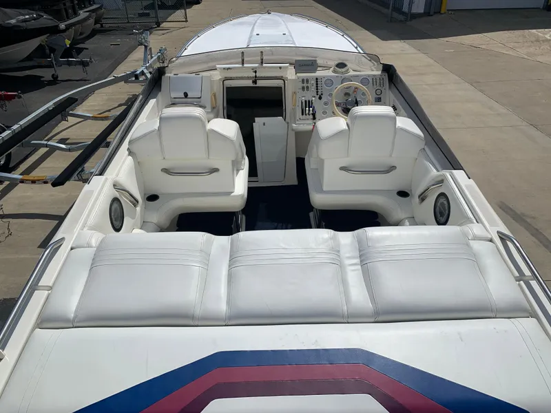 Slide: The Image of 1996 Fountain 32 Fever boat interior with white seating and dashboard controls. - 10