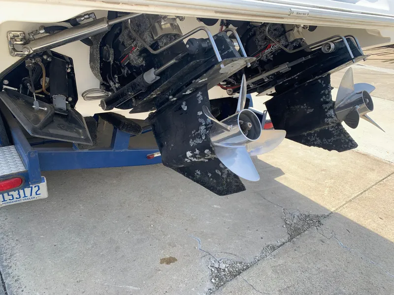 Slide: The Image of 1996 Fountain 32 Fever boat with dual outboard motors and propellers on a trailer. - 12