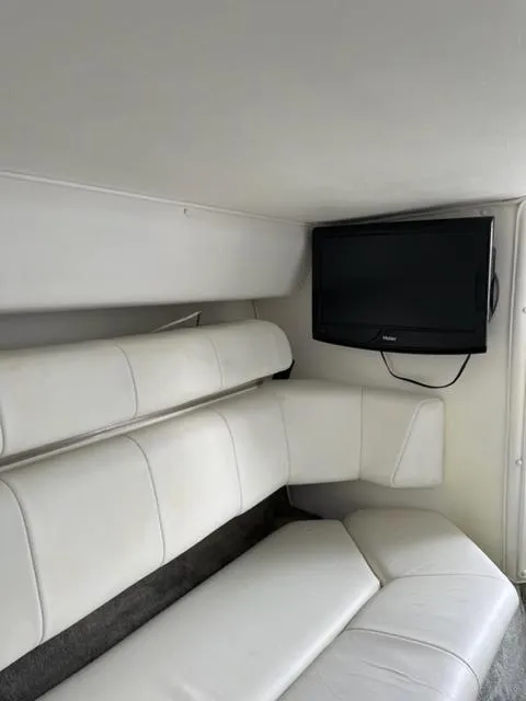 Slide: The Image of Interior of 1996 Fountain 32 Fever boat with white seating and mounted TV. - 3