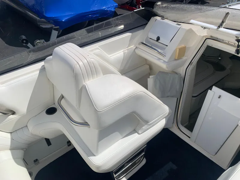 Slide: The Image of 1996 Fountain 32 Fever boat interior with white seating and storage compartments. - 5