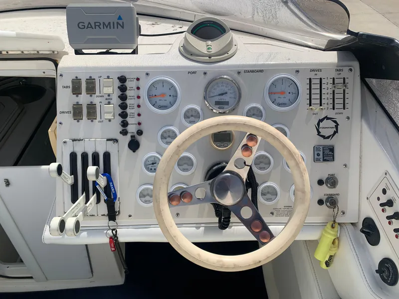 Slide: The Image of 1996 Fountain 32 Fever boat dashboard with Garmin GPS and multiple gauges. - 7